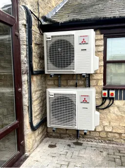 Air conditioning outdoor unit installed beside a building