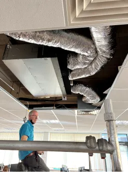 Engineer installing a ducted air conditioning unit